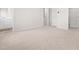 Bright bedroom featuring neutral carpet, trim, and a view into an adjoining bathroom at 605 Silverado Sunset Loop, Wendell, NC 27591
