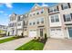 Townhome exteriors boast attached garages, neutral paint schemes, and manicured front lawns at 605 Silverado Sunset Loop, Wendell, NC 27591