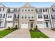 Townhome exteriors boast attached garages, neutral paint schemes, and manicured front lawns at 605 Silverado Sunset Loop, Wendell, NC 27591