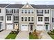 Charming townhomes showcasing a modern design, individual garages, and well-manicured landscaping at 605 Silverado Sunset Loop, Wendell, NC 27591