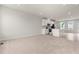 Bright living room with a modern kitchen island, stainless appliances, and hardwood floors at 605 Silverado Sunset Loop, Wendell, NC 27591