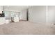 View of open-concept living space with a modern kitchen island, adjacent to a carpeted living area at 605 Silverado Sunset Loop, Wendell, NC 27591