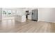 Bright living area featuring an open kitchen with island and stainless steel appliances at 605 Silverado Sunset Loop, Wendell, NC 27591