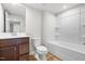 A bathroom includes a vanity with sink and mirror plus a tub shower at 607 Silverado Sunset Loop, Wendell, NC 27591
