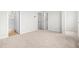 Empty bedroom with carpet and doors leading to an ensuite bathroom and walk in closet at 607 Silverado Sunset Loop, Wendell, NC 27591