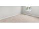 This bedroom offers neutral carpeting and a window for natural light at 607 Silverado Sunset Loop, Wendell, NC 27591