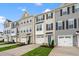 View of a row of modern townhomes with attached garages at 607 Silverado Sunset Loop, Wendell, NC 27591