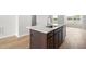 Large island with sink, light countertops and stainless appliances at 607 Silverado Sunset Loop, Wendell, NC 27591