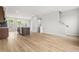 Open living space showcasing modern kitchen island and luxury vinyl flooring at 607 Silverado Sunset Loop, Wendell, NC 27591