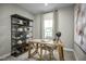 Home office features a light wood desk, shelving and grey walls creating a calm and productive space at 607 Silverado Sunset Loop, Wendell, NC 27591