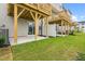 Ground level outdoor patio with sliding glass door, white privacy fence, and green lawn at 607 Silverado Sunset Loop, Wendell, NC 27591
