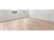 Bright bedroom featuring light wood flooring and two windows allowing natural light at 609 Silverado Sunset Loop, Wendell, NC 27591
