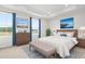Staged main bedroom with tray ceiling and picture windows with blue curtains at 609 Silverado Sunset Loop, Wendell, NC 27591