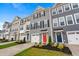 Charming townhomes with colorful front doors, attached garages, and manicured landscaping at 609 Silverado Sunset Loop, Wendell, NC 27591