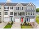 Charming townhomes with colorful doors, one-car garages, and manicured lawns at 609 Silverado Sunset Loop, Wendell, NC 27591