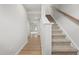 Hallway view featuring a carpeted staircase and light wood flooring at 609 Silverado Sunset Loop, Wendell, NC 27591