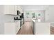 Spacious kitchen with stainless steel appliances, large center island and white cabinetry at 609 Silverado Sunset Loop, Wendell, NC 27591