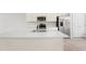 Open kitchen featuring stainless steel appliances, large island with sink, and light wood floors at 609 Silverado Sunset Loop, Wendell, NC 27591