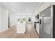 Open-concept kitchen with a large island, stainless steel appliances, and bright natural light at 609 Silverado Sunset Loop, Wendell, NC 27591