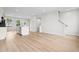 Spacious open concept living area with modern light wood floors and staircase at 609 Silverado Sunset Loop, Wendell, NC 27591