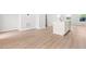 Open space with wooden floors showcasing the bright kitchen island and white cabinets at 609 Silverado Sunset Loop, Wendell, NC 27591