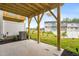 Concrete patio with wooden support beams overlooking a green lawn and townhomes at 609 Silverado Sunset Loop, Wendell, NC 27591