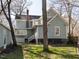 A view of the rear of the home showcasing the back yard and architectural details at 610 Peele St, Burlington, NC 27215