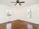 Bright bedroom features hardwood floors, ceiling fan, and windows with natural light at 610 Peele St, Burlington, NC 27215