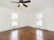Bright bedroom showing dark hardwood floors, two windows, and neutral walls at 610 Peele St, Burlington, NC 27215