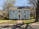 Charming two-story home with light blue siding, symmetrical windows, and a well-maintained front yard at 610 Peele St, Burlington, NC 27215