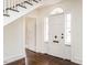 Bright foyer features hardwood floors, a white front door with sidelights, and a staircase at 610 Peele St, Burlington, NC 27215