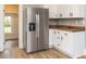 Kitchen featuring new stainless steel refrigerator and modern cabinetry with hardwood countertops at 610 Peele St, Burlington, NC 27215