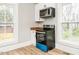 Bright kitchen boasts new stainless steel oven and microwave with natural light at 610 Peele St, Burlington, NC 27215