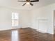 Well-lit living room showcasing hardwood floors, a fireplace, and a large window at 610 Peele St, Burlington, NC 27215