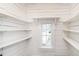 Well-lit pantry featuring ample shelving and a window with a view to the outside at 610 Peele St, Burlington, NC 27215