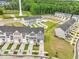 New construction aerial view of neighborhood with pond, water tower and tree line at 611 Silverado Sunset Loop, Wendell, NC 27591
