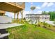 View of backyard with a concrete patio, wooden deck, green lawn and neighborhood at 611 Silverado Sunset Loop, Wendell, NC 27591