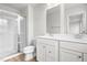 Bathroom featuring double sinks, walk-in shower, and modern fixtures at 611 Silverado Sunset Loop, Wendell, NC 27591