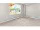 Empty bedroom with a large window offering a view of the exterior at 611 Silverado Sunset Loop, Wendell, NC 27591