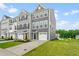 Attractive townhome with a driveway, lawn, and two-car garage at 611 Silverado Sunset Loop, Wendell, NC 27591