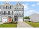 Charming townhome featuring a well-manicured lawn, grey siding, and a front-facing two-car garage at 611 Silverado Sunset Loop, Wendell, NC 27591