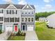 New two-story townhomes showcase modern gray siding, individual garages, and colorful front door accents at 611 Silverado Sunset Loop, Wendell, NC 27591