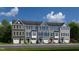 Charming new townhomes feature varied siding, black shutters, and one-car garages at 611 Silverado Sunset Loop, Wendell, NC 27591