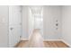 Hallway featuring multiple white doors, modern lighting, and wood-look floors at 611 Silverado Sunset Loop, Wendell, NC 27591