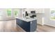Stylish kitchen with a central island, quartz countertops, stainless steel appliances, and open floorplan at 611 Silverado Sunset Loop, Wendell, NC 27591