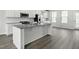 Bright, modern kitchen boasts stainless appliances, granite counters, and a center island at 611 Silverado Sunset Loop, Wendell, NC 27591