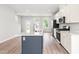 Well-lit kitchen boasting a central island, stainless steel appliances, bright cabinetry, and convenient outlets at 611 Silverado Sunset Loop, Wendell, NC 27591