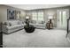 Cozy, neutral-toned living room features comfortable seating and natural light at 611 Silverado Sunset Loop, Wendell, NC 27591