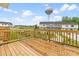 Wooden deck with wooden railing overlooks the neighborhood, a water tower, and the surrounding nature at 611 Silverado Sunset Loop, Wendell, NC 27591