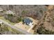 Aerial view of a home with a long driveway and well-manicured lawn and landscaping at 7100 Hasentree Club Dr, Wake Forest, NC 27587